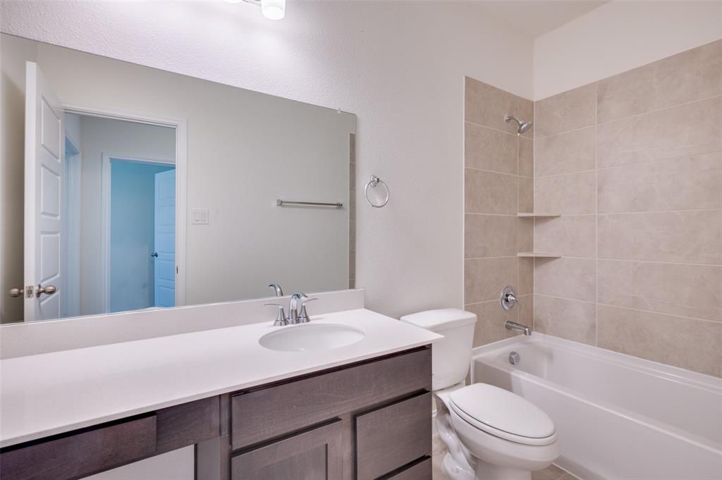 344 Fallbrook Drive Aledo, TX 76008 - Photo 13 of 28 a bathroom with a sink toilet vanity and shower