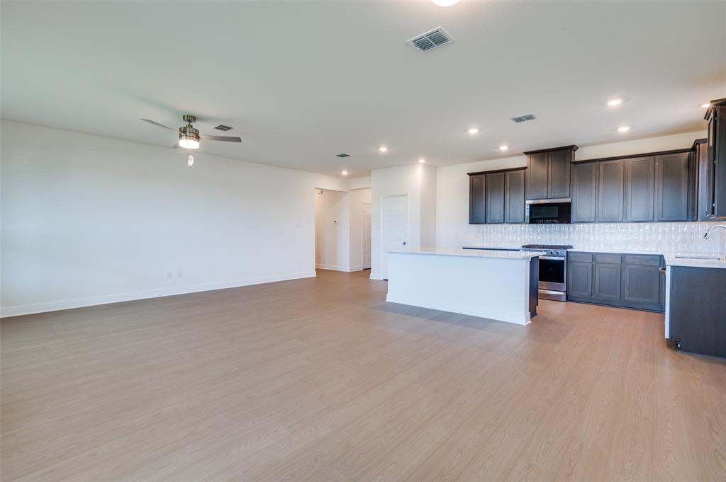 344 Fallbrook Drive Aledo, TX 76008 - Photo 4 of 28 a view of kitchen and kitchen with a sink wooden cabinets and refrigerator