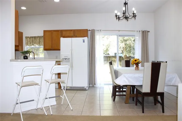 a dining room with furniture a window and kitchen view