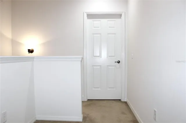 a bedroom with a bed lamp and a window