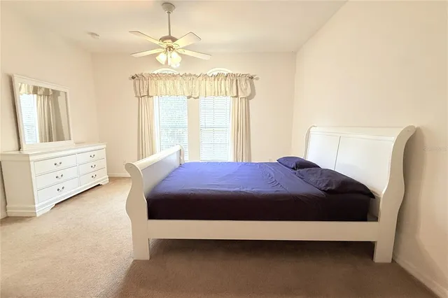 a bathroom with a granite countertop toilet sink and mirror