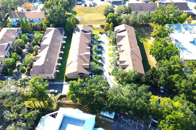 an aerial view of residential houses with outdoor space