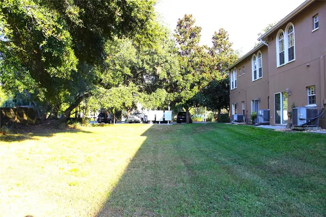 a view of yard with swimming pool and green space