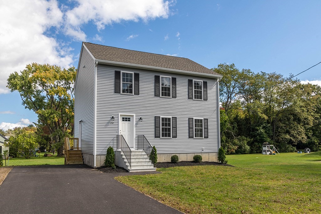 a front view of a house with a yard