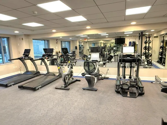 a room with gym equipment and a large window