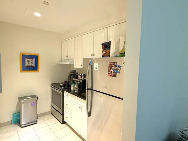 a kitchen with a refrigerator and a stove