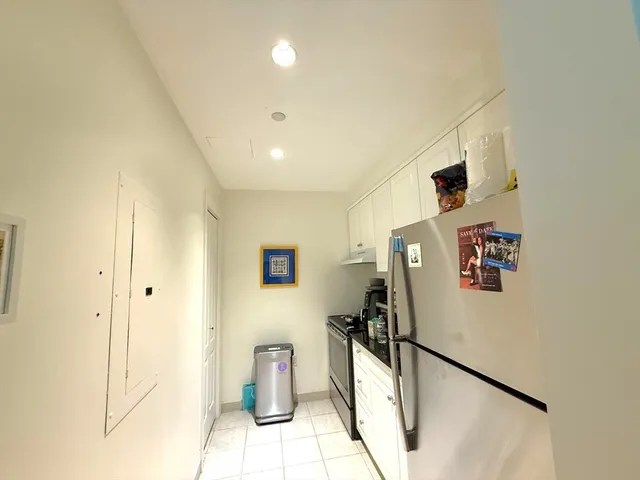 a living room with furniture and book shelf