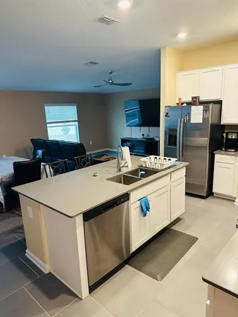 a kitchen that has a lot of cabinets in it