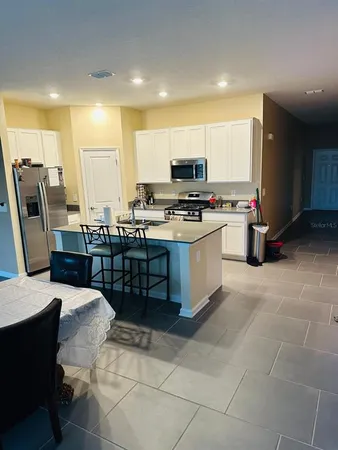 a kitchen with a sink and a stove top oven