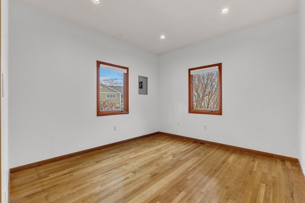 16 Carthay Circle, Unit 16 Newton, MA 02461 - Photo 14 of 29 a view of an empty room with wooden floor and a window