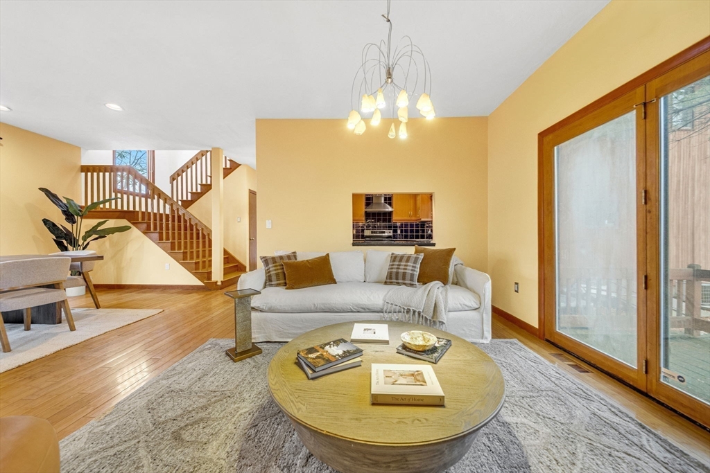 16 Carthay Circle, Unit 16 Newton, MA 02461 - Photo 9 of 29 a view of a livingroom with furniture a chandelier and wooden floor