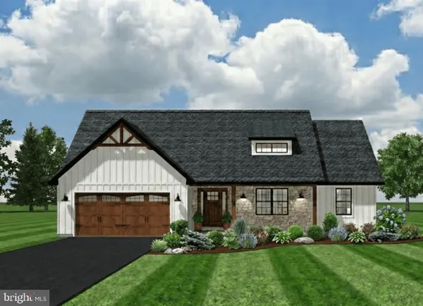 a front view of a house with a garden and yard