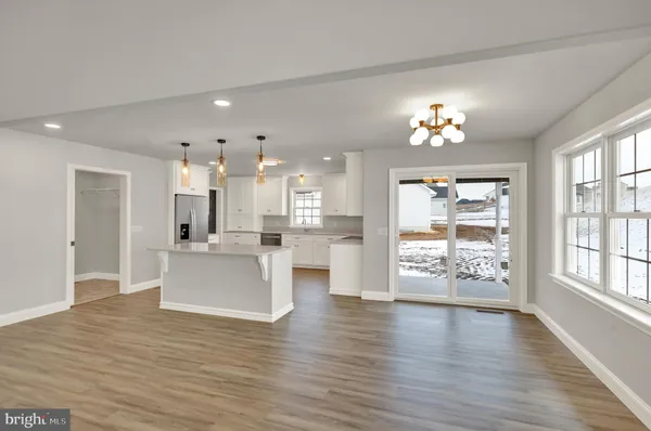 a view of a living room kitchen and a wooden floor