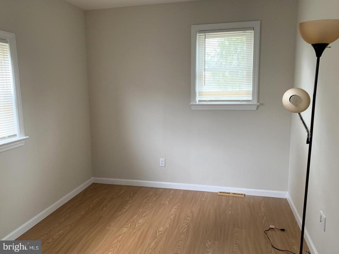 38 Hazelhurst Avenue Ewing, NJ 08638 - Photo 5 of 10 an empty room with wooden floor and windows