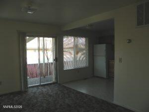 366 Quail Way Fallon, NV 89406 - Photo 14 of 18 an empty room with wooden floor and windows