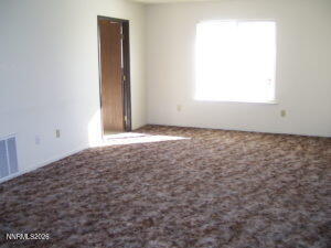 366 Quail Way Fallon, NV 89406 - Photo 2 of 18 an empty room with a window