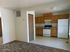 366 Quail Way Fallon, NV 89406 - Photo 7 of 18 a kitchen with a refrigerator and a stove