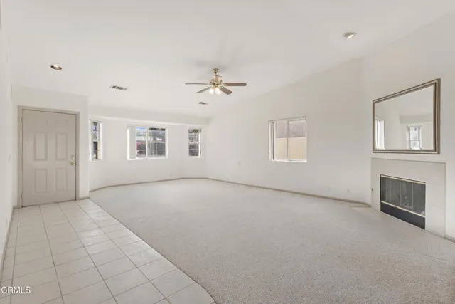 a view of a livingroom with an empty space and a ceiling fan