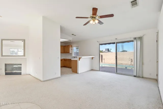 a kitchen with stainless steel appliances a refrigerator cabinets and wooden floor