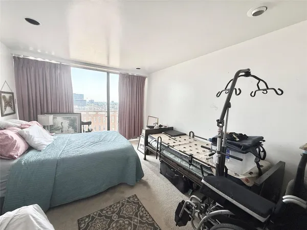 a bedroom with furniture and a window