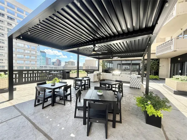 a view of a patio with table and chairs and potted plants