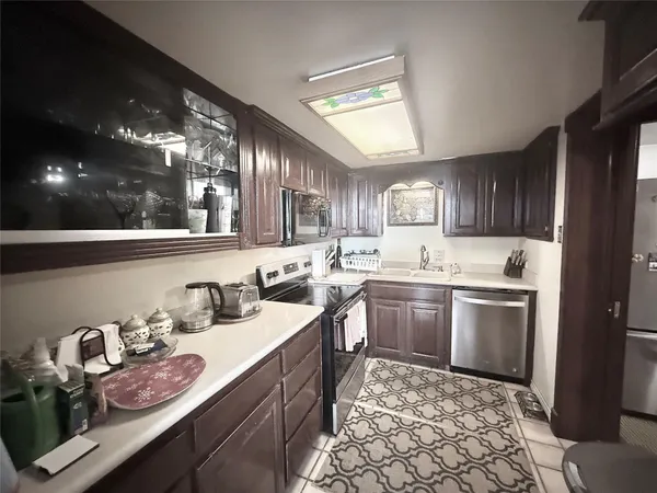 a kitchen with granite countertop wooden cabinets and white appliances