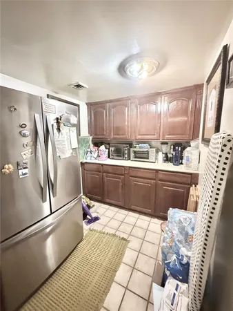 a kitchen with a sink stainless steel appliances and a window