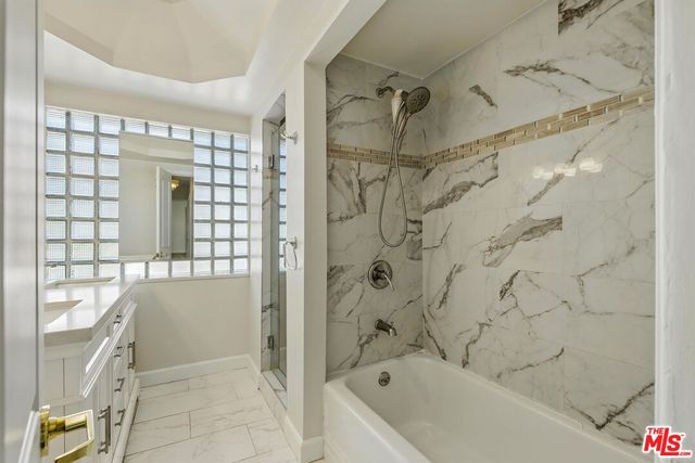 a bathroom with a bathtub and shower