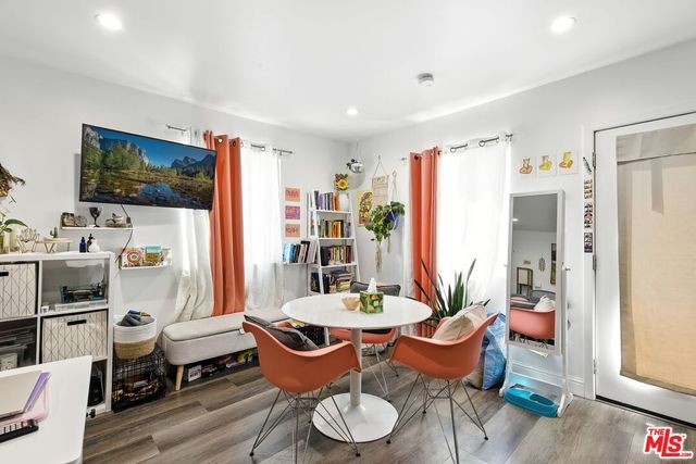 a view of kitchen with stainless steel appliances granite countertop a refrigerator and a sink