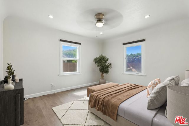 a bedroom with a large bed and a window