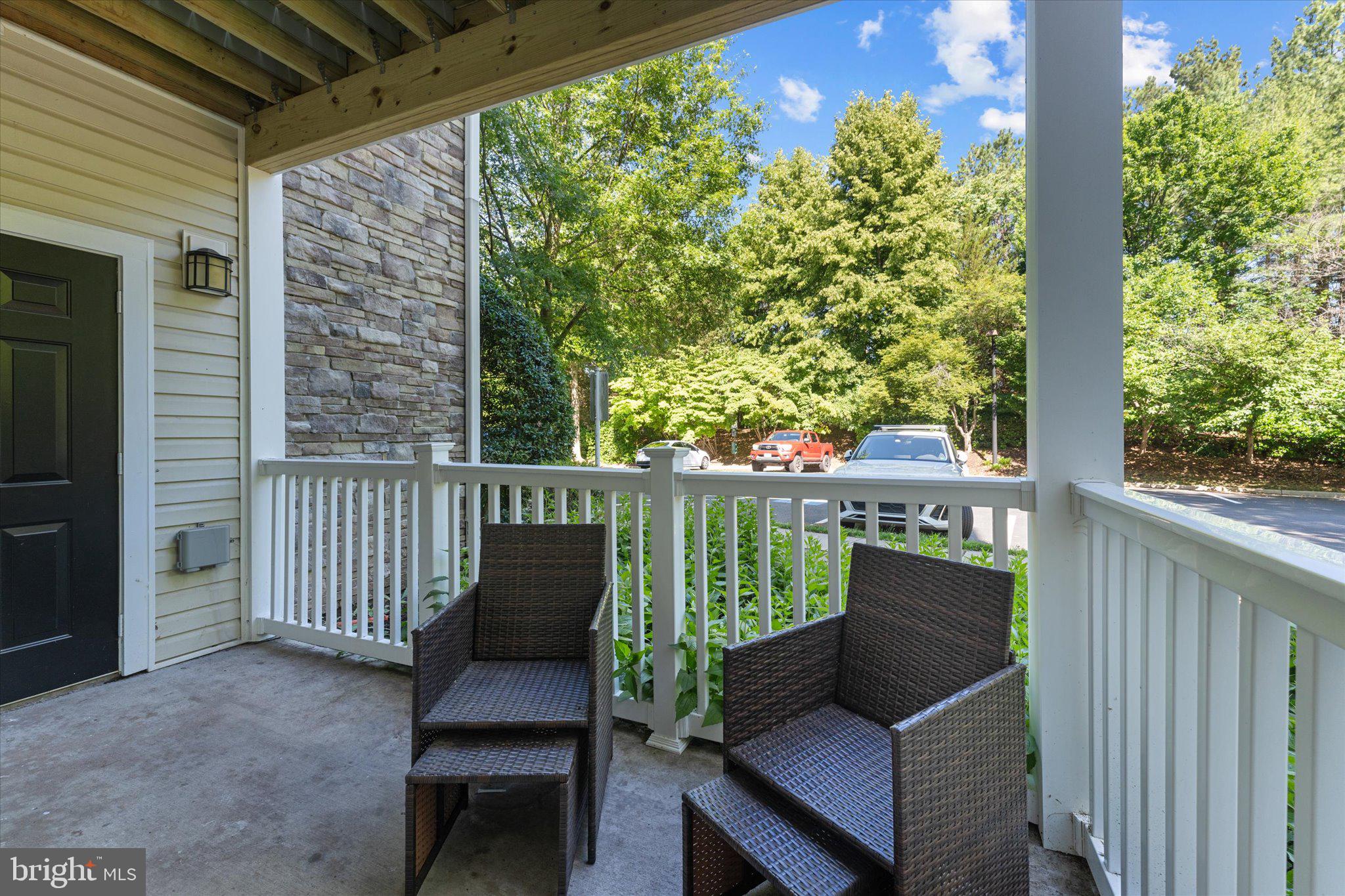 503 Sunset View Terrace Southeast, Unit 101 Leesburg, VA 20175 - Photo 29 of 39 Serene porch with lush greenery view.