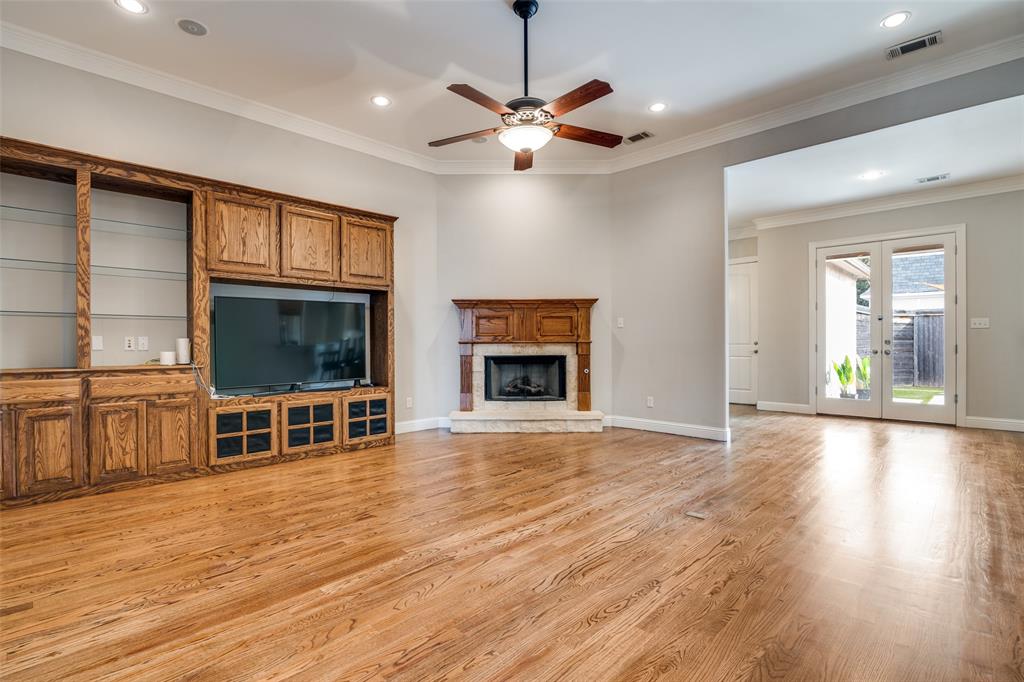 711 Ridgeview Drive Rockwall, TX 75087 - Photo 11 of 39 a view of a livingroom with a fireplace wooden floor and chandelier