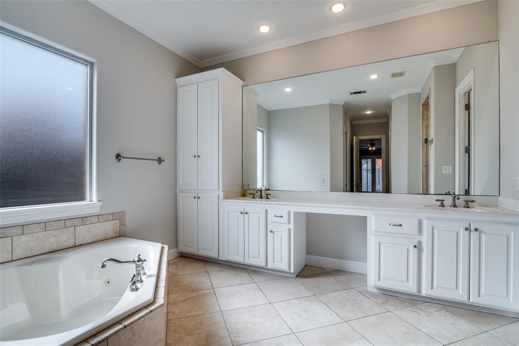 711 Ridgeview Drive Rockwall, TX 75087 - Photo 19 of 39 a spacious en suite bathroom with a granite countertop sink and mirror