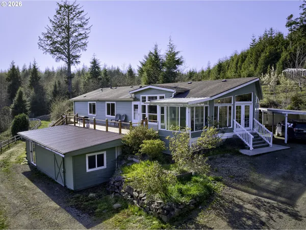 a front view of house with yard and trees around