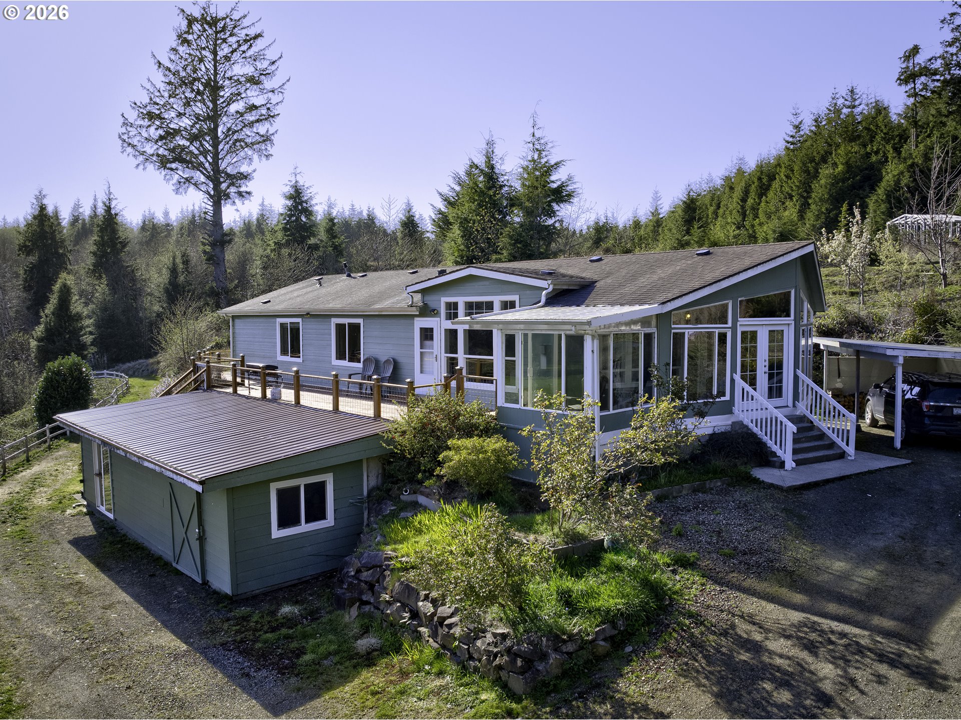 a front view of house with yard and trees around