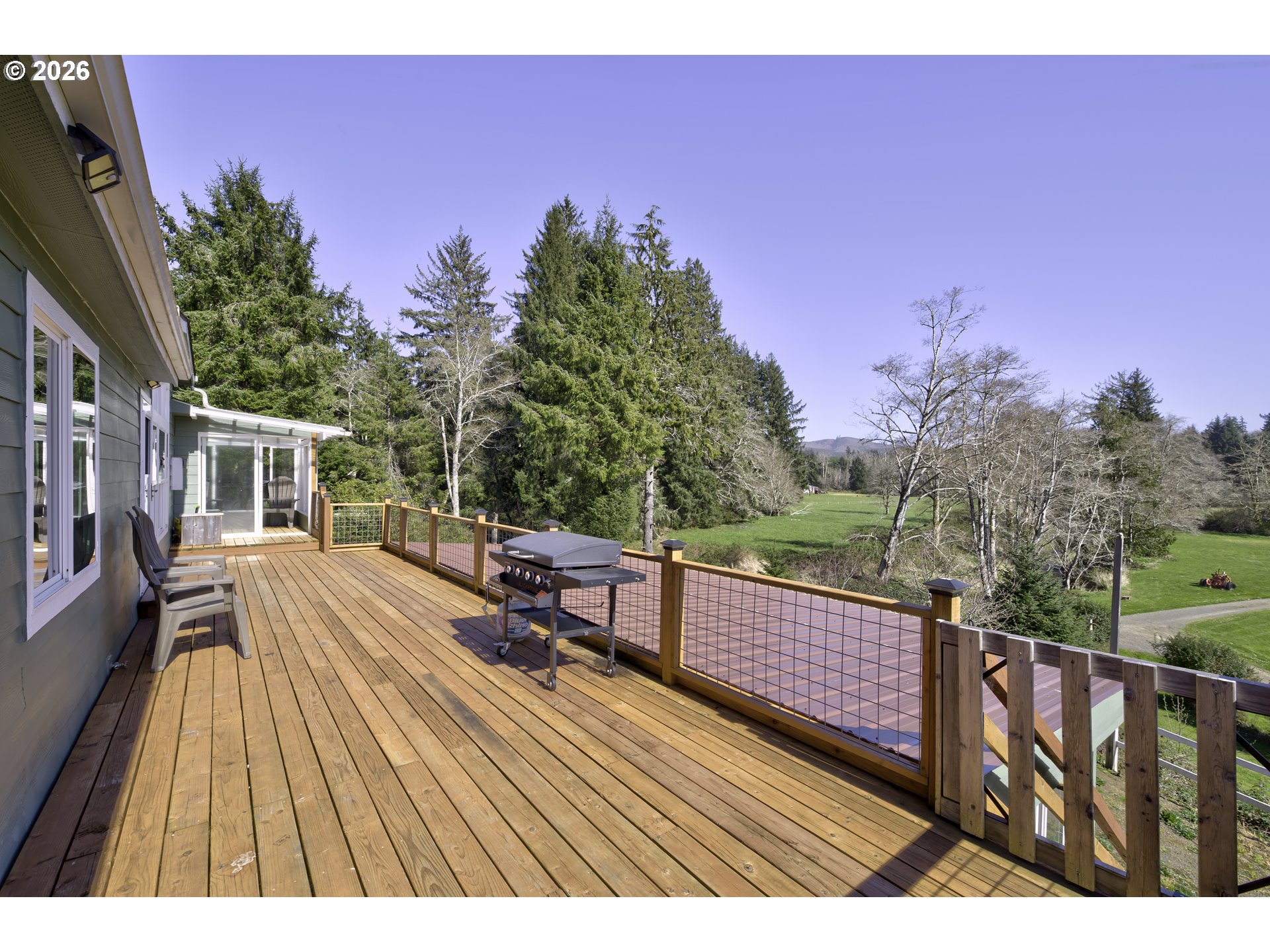 47 North Nemah Road East South Bend, WA 98586 - Photo 19 of 33 a view of a balcony with wooden floor and outdoor seating