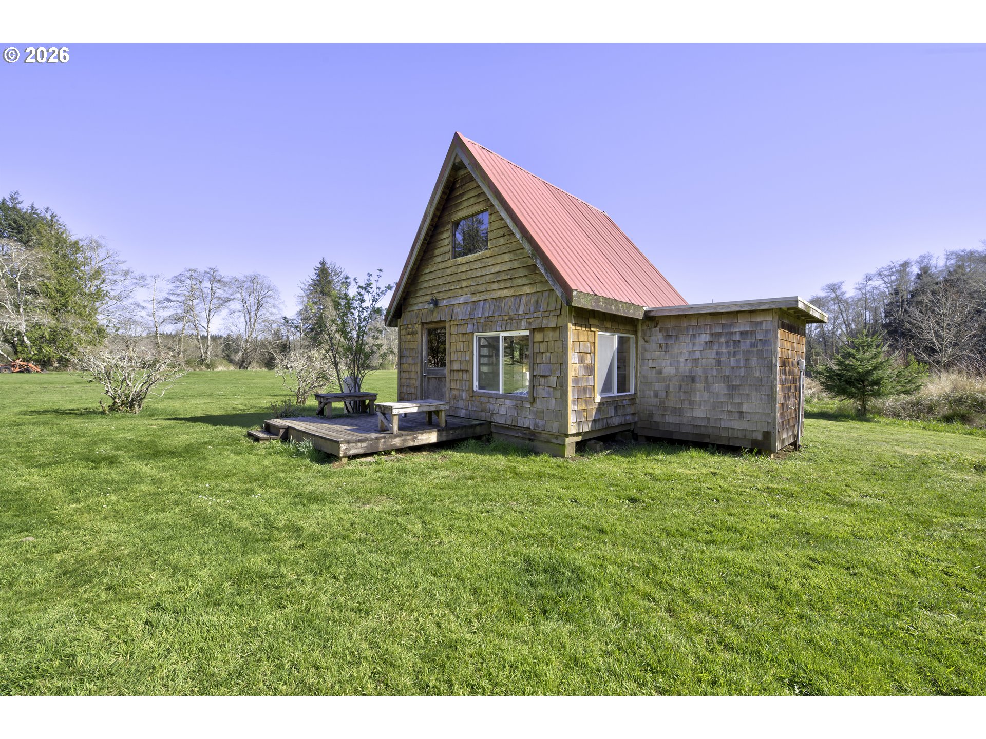 47 North Nemah Road East South Bend, WA 98586 - Photo 21 of 33 a backyard of a house with table and chairs