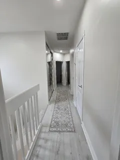 a bedroom with a bed lamp and a fireplace