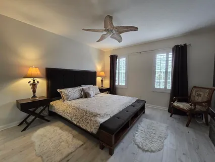 a bedroom with a bed and a flat tv screen on dresser