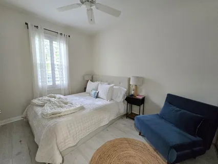 a bedroom with a bed and a large mirror