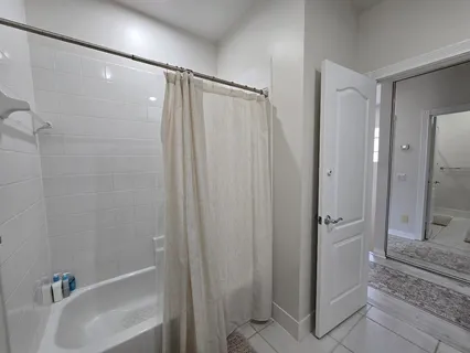 a spacious bathroom with a granite countertop sink and a mirror