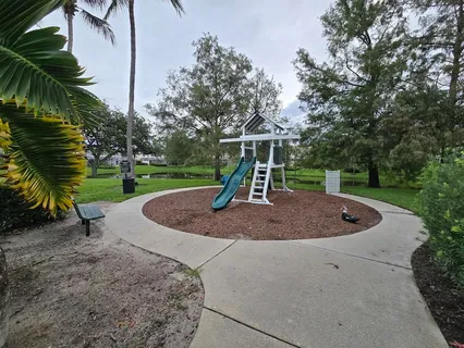 a view of a swimming pool with a table and chairs
