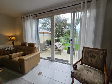 a living room with furniture and a floor to ceiling window