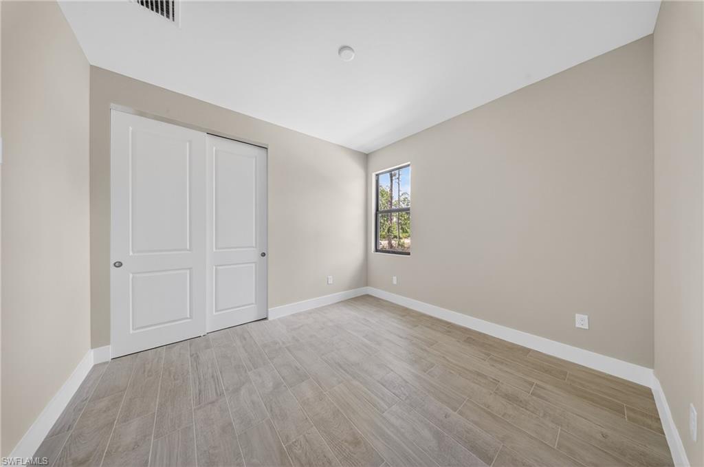 18 Scott Avenue Lehigh Acres, FL 33936 - Photo 20 of 37 an empty room with windows
