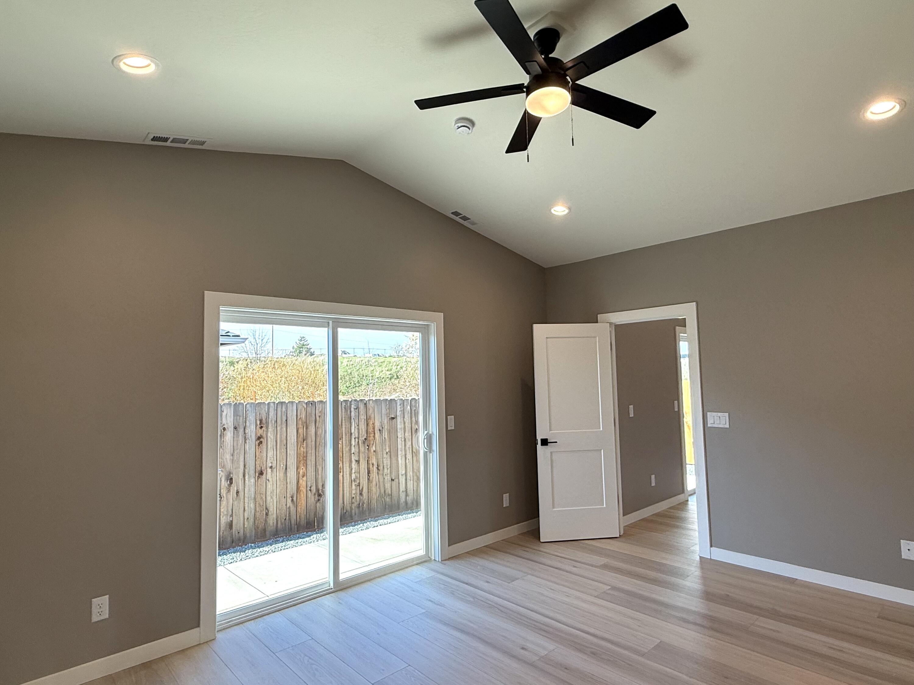 337 Quail Circle Talent, OR 97540 - Photo 13 of 25 an empty room with wooden floor and windows