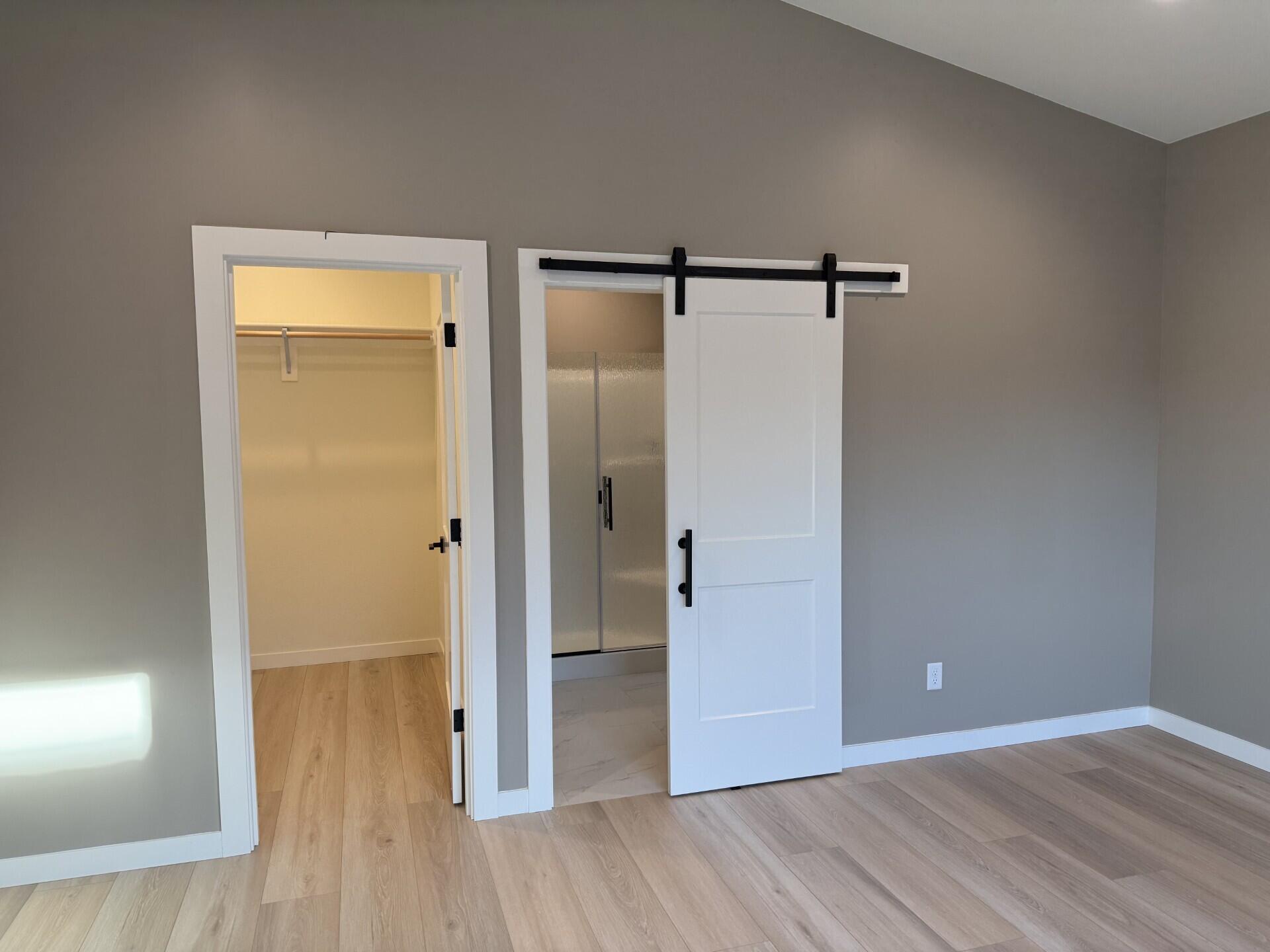 337 Quail Circle Talent, OR 97540 - Photo 14 of 25 a view of an empty room with wooden floor and a bathroom