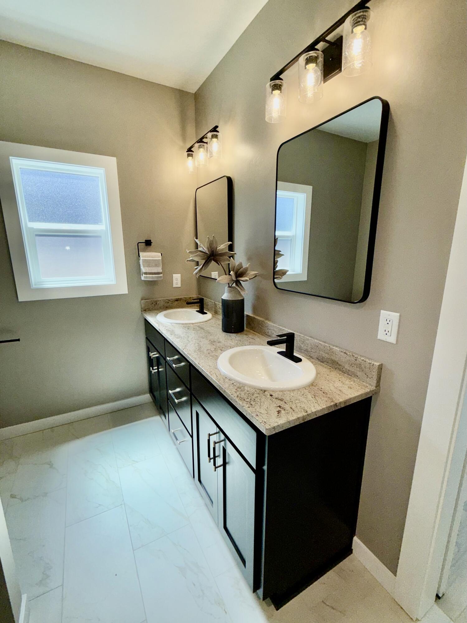 337 Quail Circle Talent, OR 97540 - Photo 16 of 25 a bathroom with a granite countertop sink a mirror and vanity