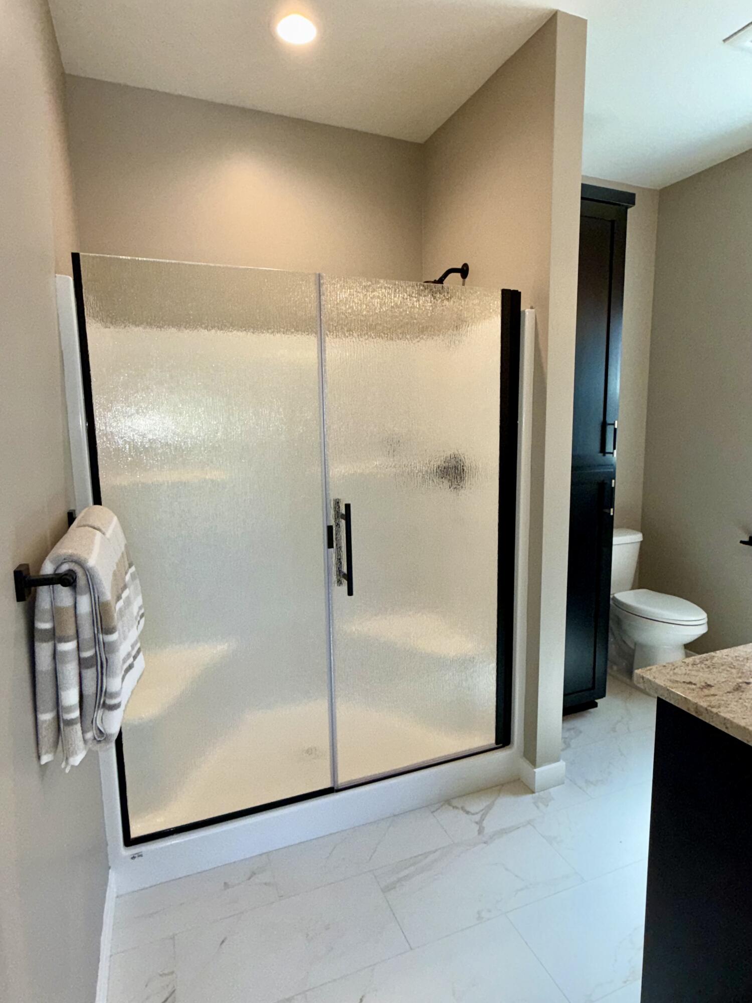 337 Quail Circle Talent, OR 97540 - Photo 17 of 25 a bathroom with a granite countertop shower a toilet and a sink