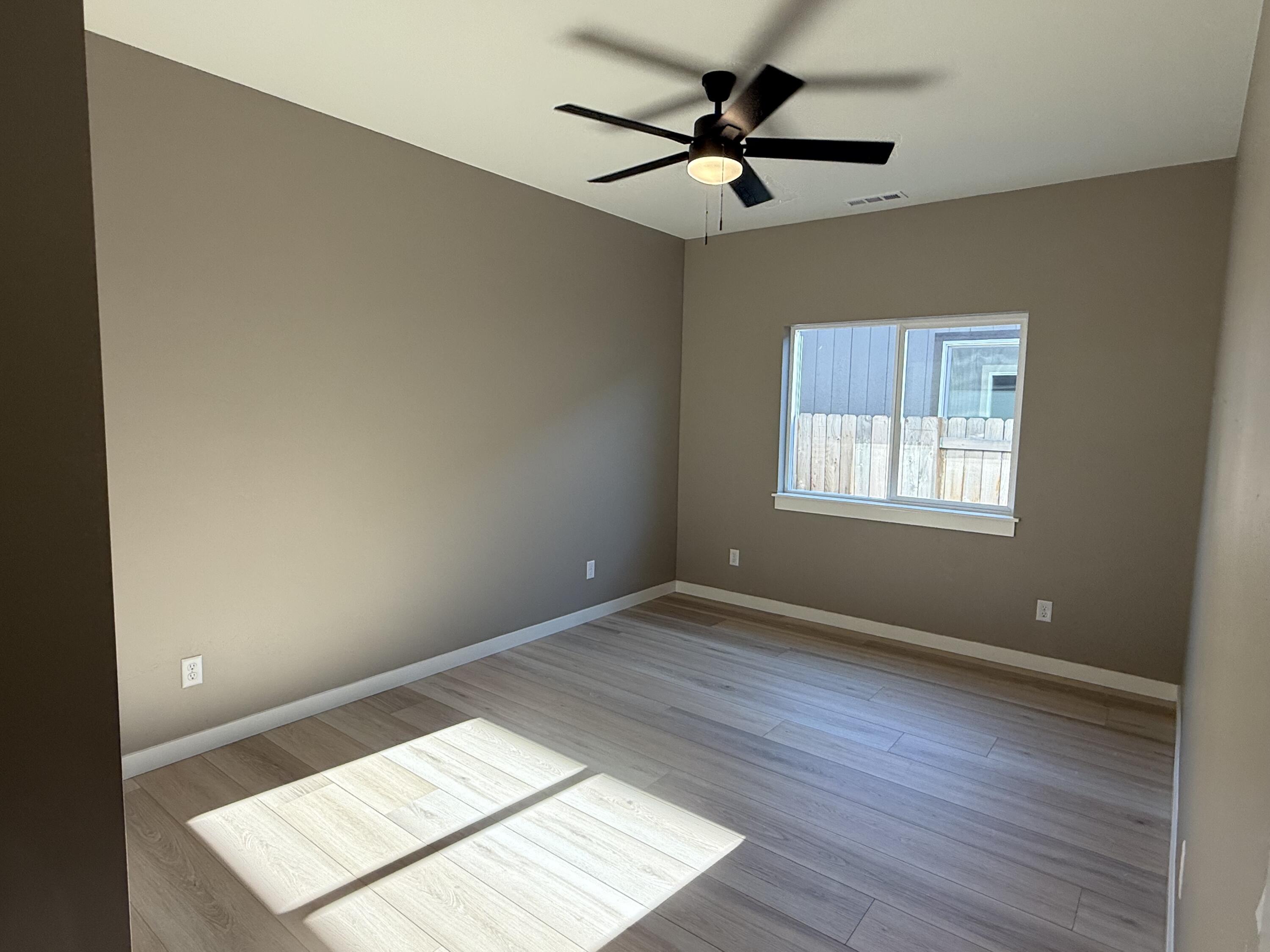 337 Quail Circle Talent, OR 97540 - Photo 19 of 25 an empty room with wooden floor and windows