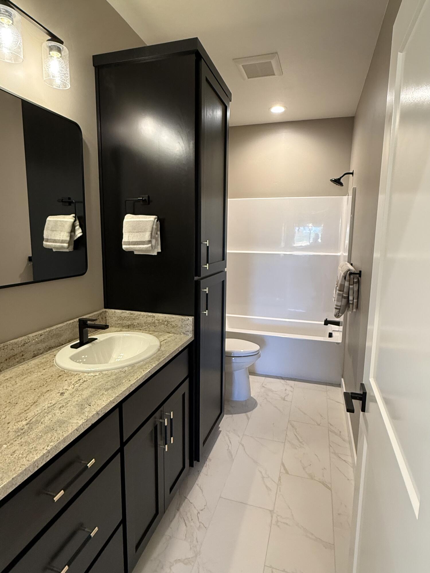 337 Quail Circle Talent, OR 97540 - Photo 20 of 25 a bathroom with a granite countertop sink toilet and mirror
